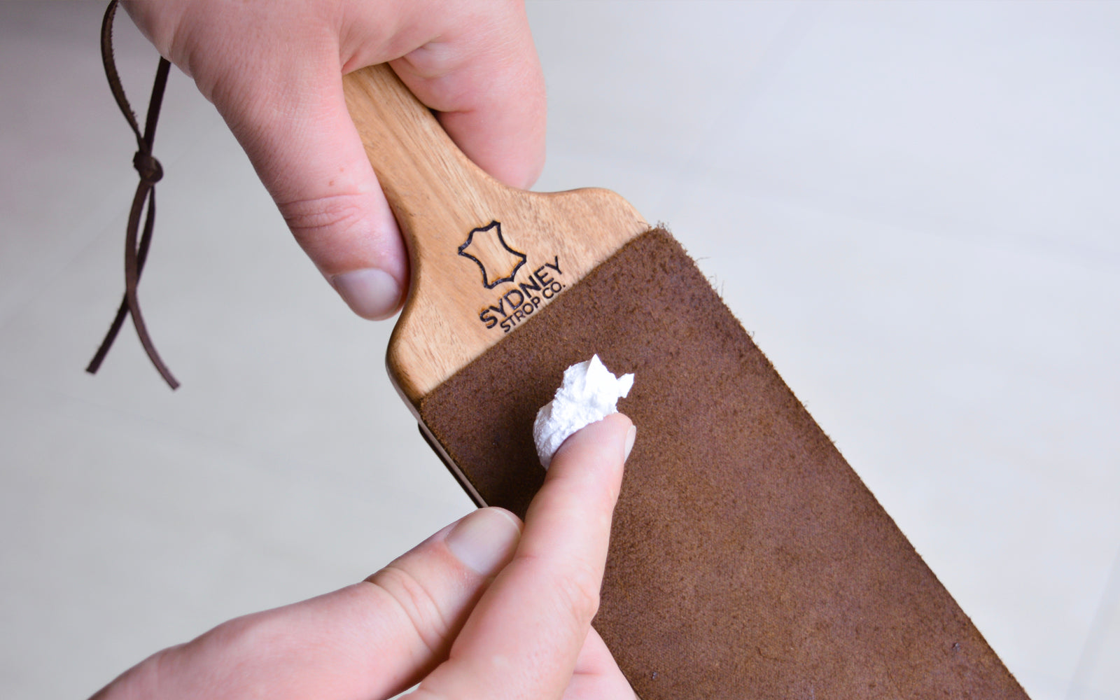 Applying strop paste